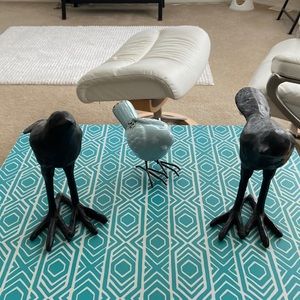 Ceramic blue bird, feet are metal. Black birds I’m not sure what metal .